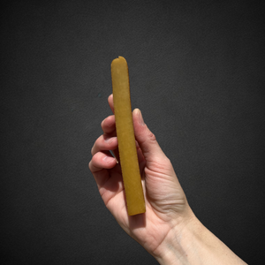 A photo of a hand holding a medium yak chew